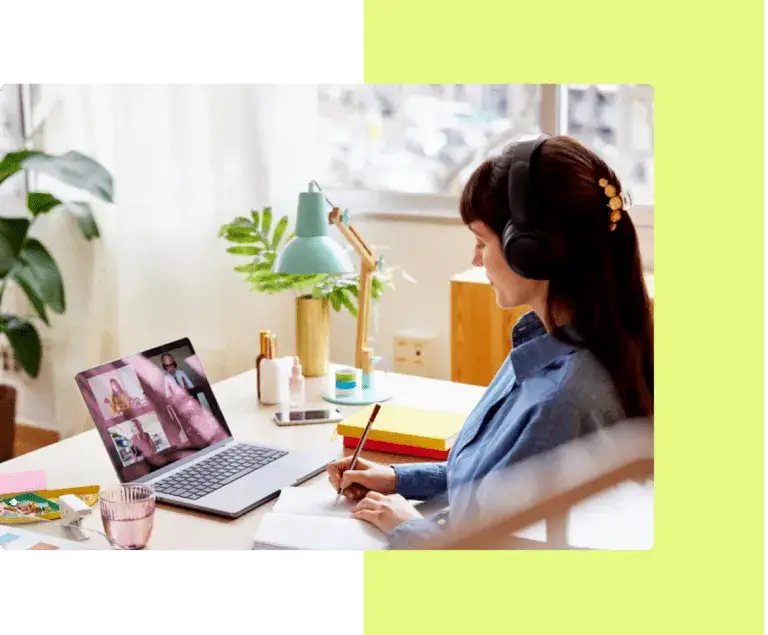 A focused publisher with headphones working on a digital magazine layout on a laptop, symbolizing eMagazines' commitment to responsive support and innovation