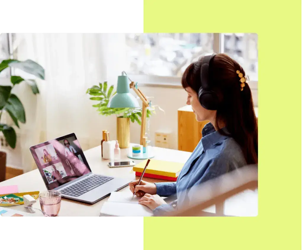 A focused publisher with headphones working on a digital magazine layout on a laptop, symbolizing eMagazines' commitment to responsive support and innovation