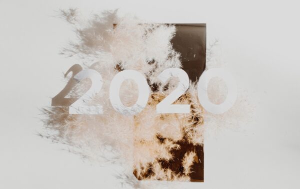 white numbers 2020 with sparklers in background