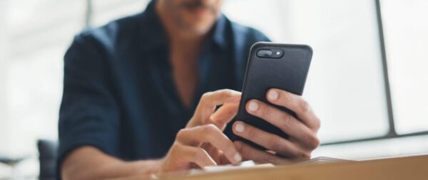 Close-up photo of male hands with smartphone
