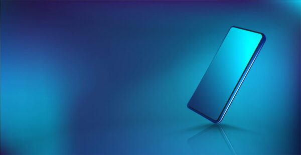 mobile phone freestanding tilted on blue background