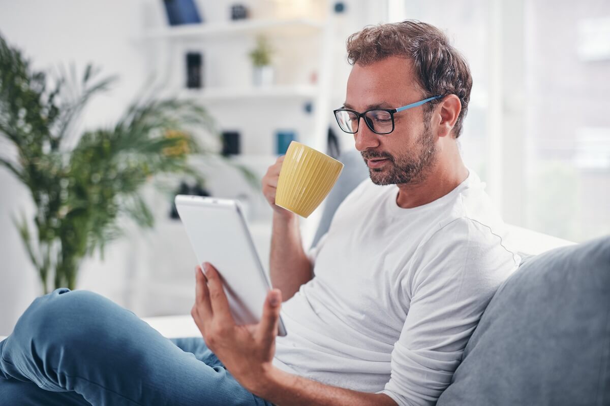 man reading on tablet